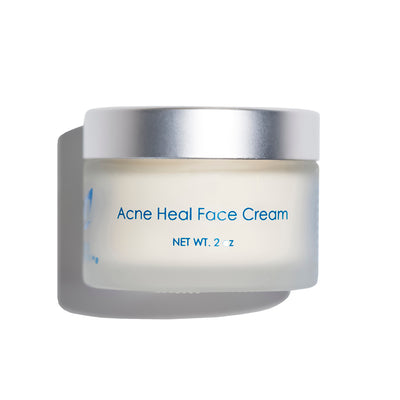 Acne Heal Face Cream jar from Blue Monarch, a face cream for pimples, featuring a frosted container with a silver lid.